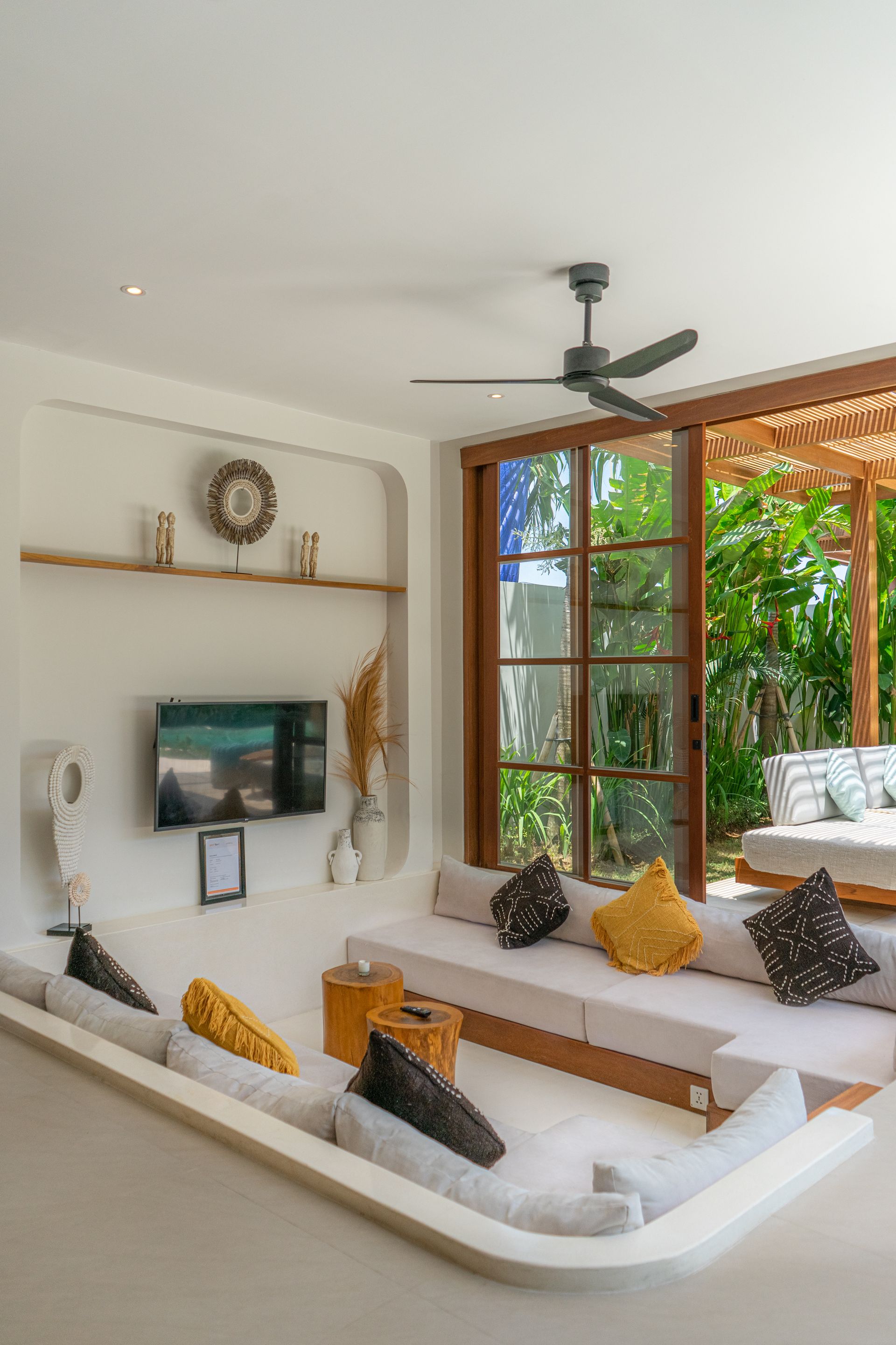 Calm Bali villa living room opening onto a tropical garden